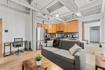 a living room with a couch and a table at Downtown Loft l Cleveland l Parking l Cafe in Cleveland