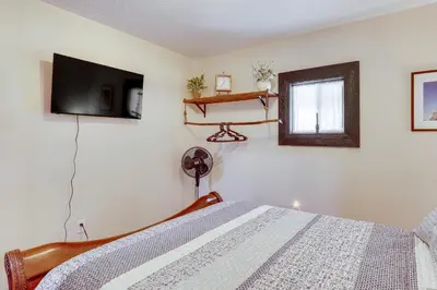 a bedroom with a bed and a flat screen tv at 6 Mi to Main Street Dog-Friendly Home in Dover! in Dover