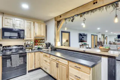 a kitchen with wooden cabinets and a stove top oven at 6 Mi to Main Street Dog-Friendly Home in Dover! in Dover