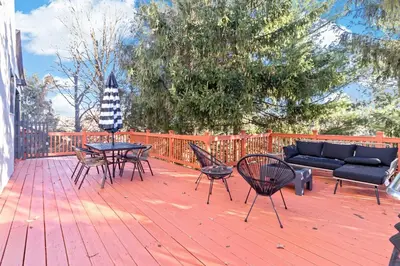 a patio with a couch and chairs on a wooden deck at The Green Escape in Oakley 2 bed 1 bath in Cincinnati