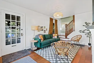 a living room with a green couch and a table at The Green Escape in Oakley 2 bed 1 bath in Cincinnati
