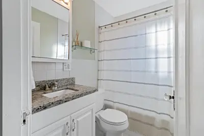 a white bathroom with a toilet and a sink at The Green Escape in Oakley 2 bed 1 bath in Cincinnati