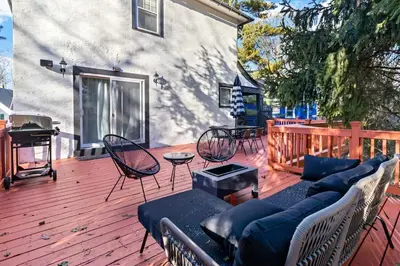 a patio with a couch and chairs on a wooden deck at The Green Escape in Oakley 2 bed 1 bath in Cincinnati