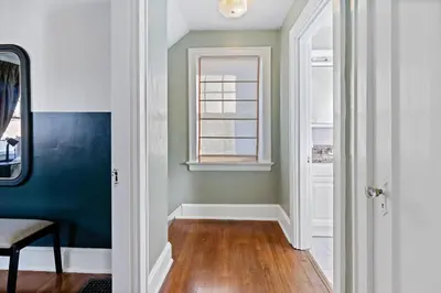 a room with a blue wall and a window at The Green Escape in Oakley 2 bed 1 bath in Cincinnati