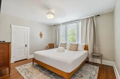 a bedroom with a large bed and a window at Cozy Urban Farmhouse 3bd1andhalfbth in Cincinnati