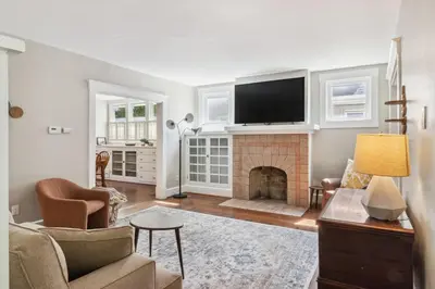 a living room with a fireplace and a flat screen tv at Cozy Urban Farmhouse 3bd1andhalfbth in Cincinnati