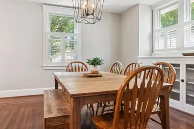 a dining room with a wooden table and chairs at Cozy Urban Farmhouse 3bd1andhalfbth in Cincinnati
