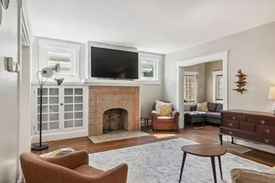 a living room with a fireplace with a flat screen tv at Cozy Urban Farmhouse 3bd1andhalfbth in Cincinnati