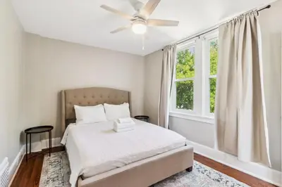 a bedroom with a bed and a ceiling fan at Cozy Urban Farmhouse 3bd1andhalfbth in Cincinnati