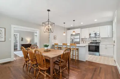 a kitchen and dining room with a wooden table and chairs at Cozy Urban Farmhouse 3bd1andhalfbth in Cincinnati