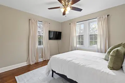 a bedroom with a bed and a ceiling fan at Inviting 4BR2BA in Oakley with 2 Park Spots & Lg Deck in Cincinnati