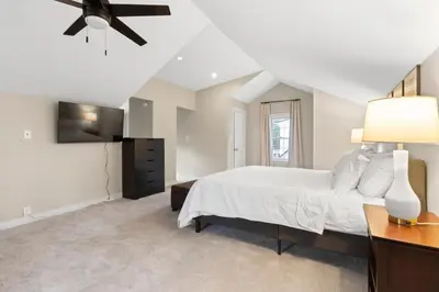 a bedroom with a bed and a ceiling fan at Inviting 4BR2BA in Oakley with 2 Park Spots & Lg Deck in Cincinnati