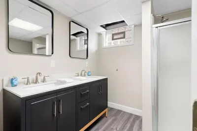 a bathroom with a sink and two mirrors at Inviting 4BR2BA in Oakley with 2 Park Spots & Lg Deck in Cincinnati