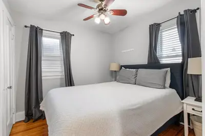 a bedroom with a bed with a ceiling fan at HydePark Abode Two 1st flr bedrms in Cincinnati