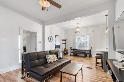 a living room with a leather couch and a table at HydePark Abode Two 1st flr bedrms in Cincinnati
