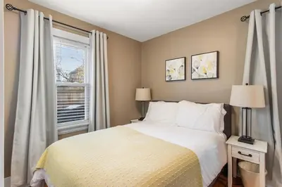 a bedroom with a bed and a window at HydePark Abode Two 1st flr bedrms in Cincinnati