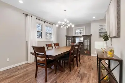 a dining room with a wooden table and chairs at Newly renovated Spacious & Cozy 3Bd Home in Oakley in Cincinnati