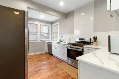 a kitchen with white cabinets and a stove top oven at Newly renovated Spacious & Cozy 3Bd Home in Oakley in Cincinnati