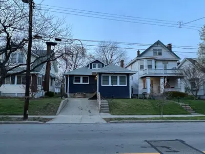 a blue house on a street with houses at Newly renovated Spacious & Cozy 3Bd Home in Oakley in Cincinnati