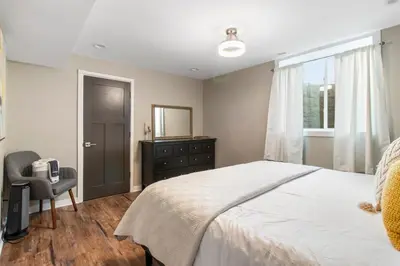 a bedroom with a bed and a dresser and a mirror at Newly renovated Spacious & Cozy 3Bd Home in Oakley in Cincinnati