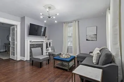 a living room with a couch and a tv at Walkable and Central with 1st flr bedroom and bathroom in Cincinnati
