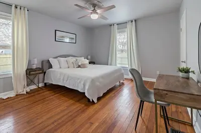 a white bedroom with a bed and a ceiling fan at Walkable and Central with 1st flr bedroom and bathroom in Cincinnati