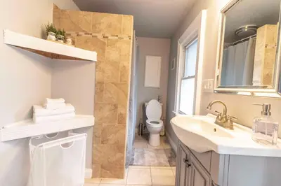 a bathroom with a toilet and a sink and a mirror at Walkable and Central with 1st flr bedroom and bathroom in Cincinnati