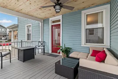 a porch with a couch and a ceiling fan at Walkable and Central with 1st flr bedroom and bathroom in Cincinnati