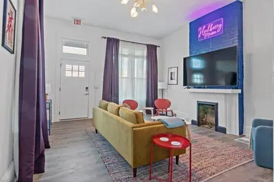 a living room with a couch and a tv at WalnutHills Mansion-sleeps14! TVs in every room! in Cincinnati