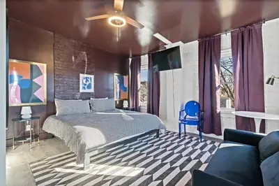 a bedroom with a bed and a ceiling fan at WalnutHills Mansion-sleeps14! TVs in every room! in Cincinnati