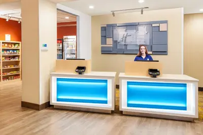 a woman standing at a counter in a store at Holiday Inn Express & Suites Sandusky by IHG in Sandusky