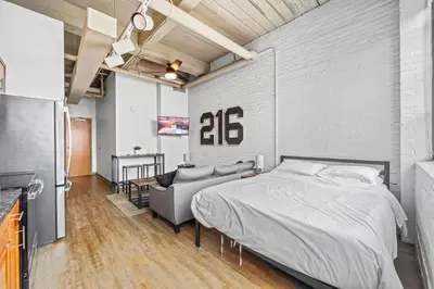 a bedroom with a bed and a couch at Studio Apt In DT l Parking l Fast Wi-fi l Café in Cleveland