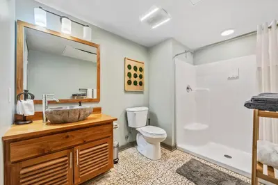 a bathroom with a sink and a toilet and a shower at Studio Apt In DT l Parking l Fast Wi-fi l Café in Cleveland