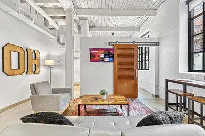 a living room with a couch and a table at Brooklyn Style Loft l DT l Parking l Cafe in Cleveland