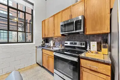 a kitchen with a stove and a microwave at Brooklyn Style Loft l DT l Parking l Cafe in Cleveland