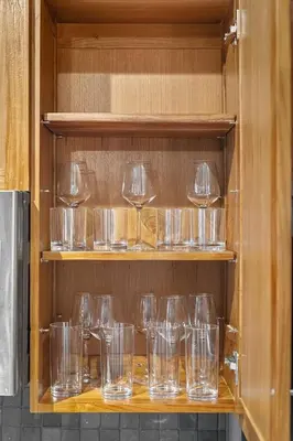 a bunch of empty glasses sitting on a shelf at Brooklyn Style Loft l DT l Parking l Cafe in Cleveland