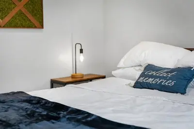 a bed with a blue pillow on top of it at Brooklyn Style Loft l DT l Parking l Cafe in Cleveland