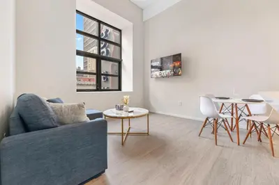 a living room with a couch and a table at Luxury DT Condo l Playhouse Square l Fast W-Fi in Cleveland
