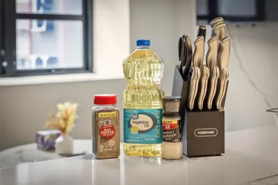 a bottle of oil next to a knife block and a bottle of mustard at Luxury DT Condo l Playhouse Square l Fast W-Fi in Cleveland
