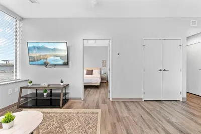 a living room with white walls and wooden floors at Near DT & CLE Clinic Queen Bed Wi-Fi Parking in Cleveland