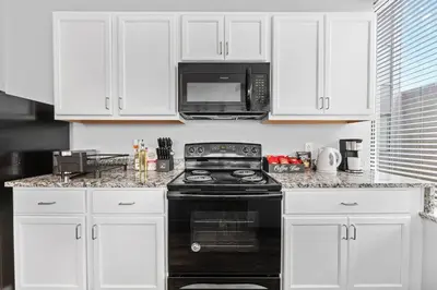 a kitchen with a black stove and a microwave at Near DT & CLE Clinic Queen Bed Wi-Fi Parking in Cleveland