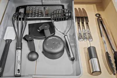 a bunch of kitchen utensils sitting on a counter at MDRN Escape with Natural Light Wi-Fi Gym Parking in Cleveland