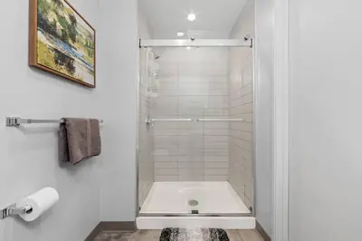 a shower with a glass door in a bathroom at MDRN Escape with Natural Light Wi-Fi Gym Parking in Cleveland
