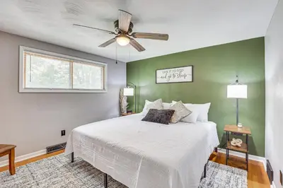 a bedroom with a bed and a ceiling fan at Fish, Hike and Golf Leisurely Navarre Home with Yard! in Navarre
