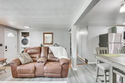 a living room with a brown leather chair and a table at Fish, Hike and Golf Leisurely Navarre Home with Yard! in Navarre