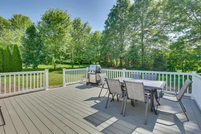 a deck with a table and chairs and a grill at Fish, Hike and Golf Leisurely Navarre Home with Yard! in Navarre