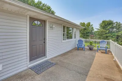 two blue chairs sitting on the front porch of a house at Fish, Hike and Golf Leisurely Navarre Home with Yard! in Navarre
