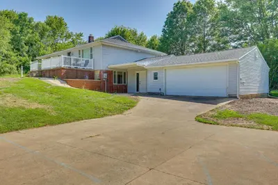 a large white house with a garage at Fish, Hike and Golf Leisurely Navarre Home with Yard! in Navarre