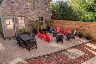 a patio with chairs and tables and a fence at Short North 1BR King Bed Fire Pit & Free Parking in Columbus