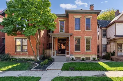 a brick house with a tree in the front yard at Short North 1BR King Bed Fire Pit & Free Parking in Columbus